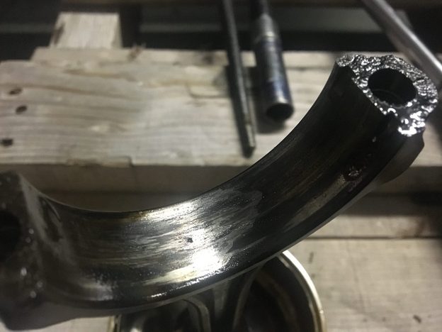 Close-up of the connecting rod with its bearing missing.