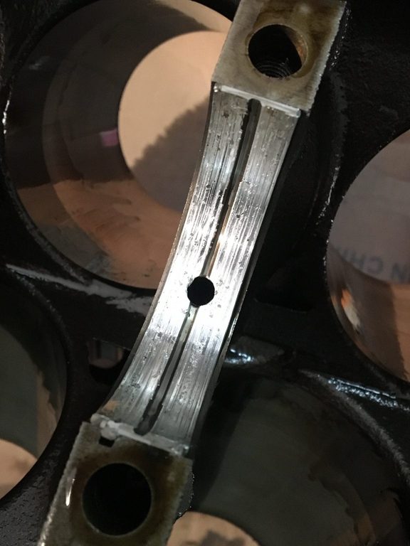 Close-up of a grooved bearing surface inside the disassembled engine.