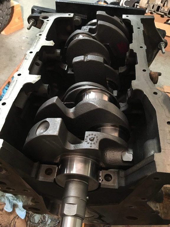 Crankshaft resting in the open engine block, with shiny journals visible.